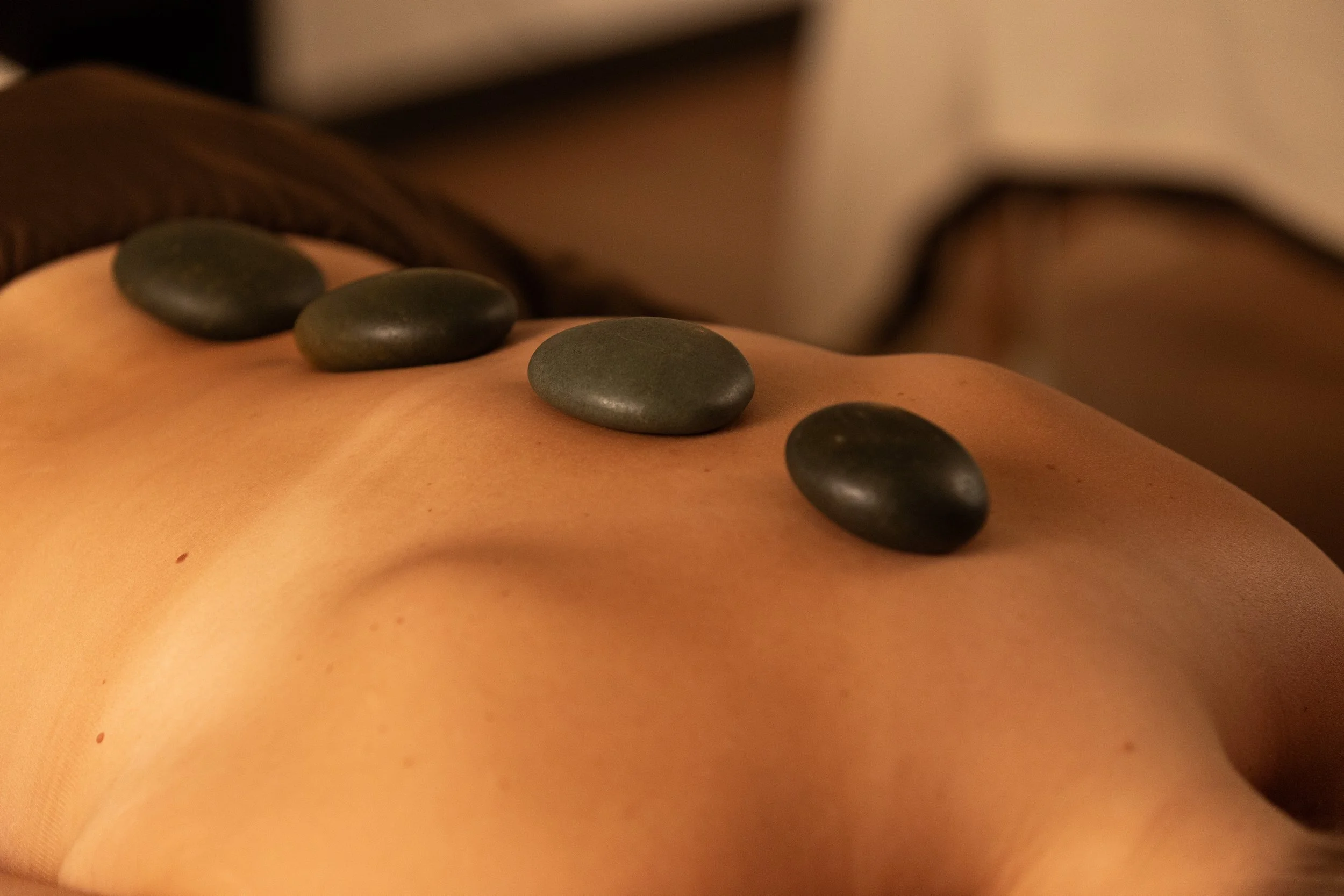 Hot stones placed along a client's back during a hot stone massage