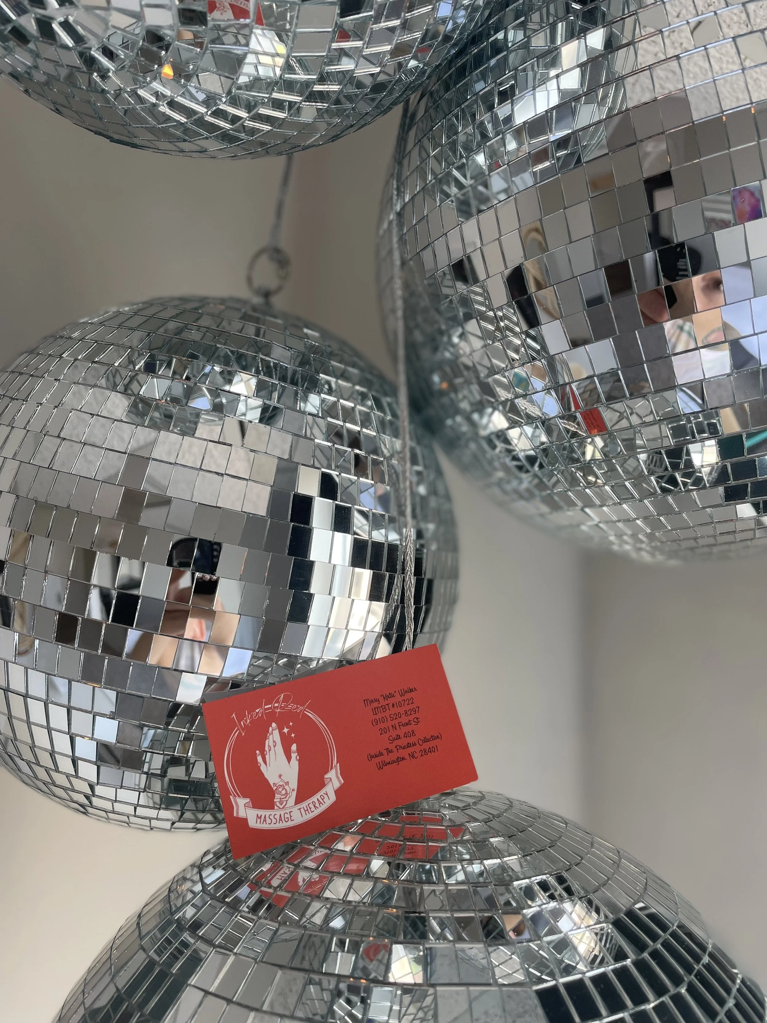 Disco balls hanging in the Inked Red studio